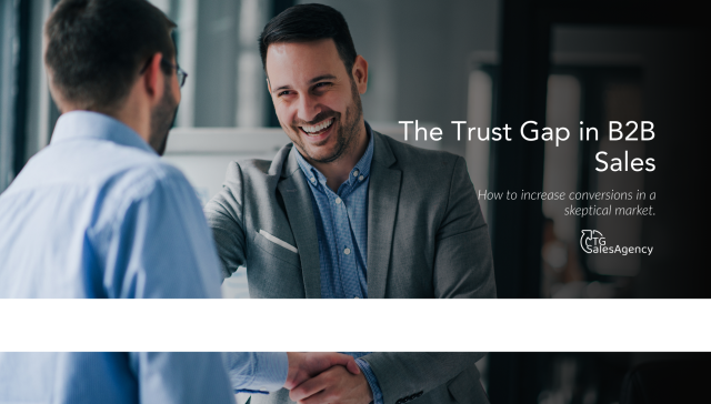 Business professionals shaking hands, representing building buyer trust to increase B2B sales conversions