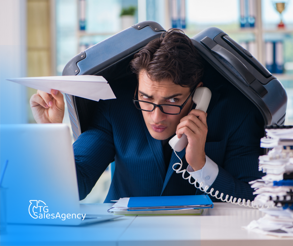 Overwhelmed sales professional buried in work representing poor sales hiring decisions, burnout, and ineffective sales performance.