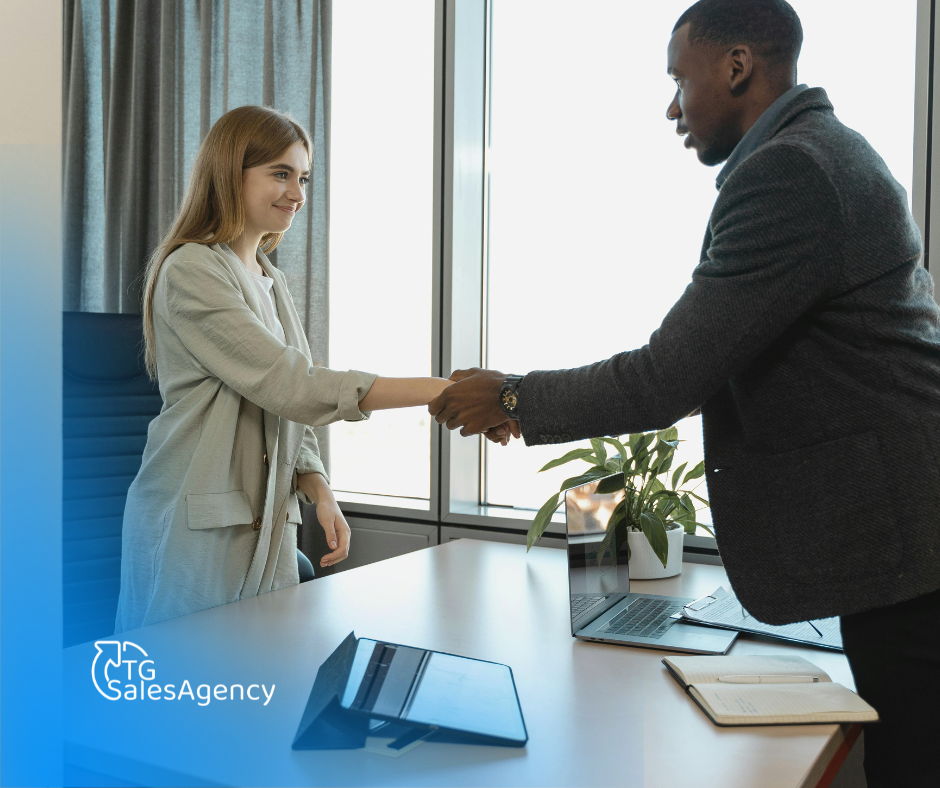Sales manager shaking hands with a job candidate during a professional sales interview about identifying strong sales talent and hiring top-performing sales reps.